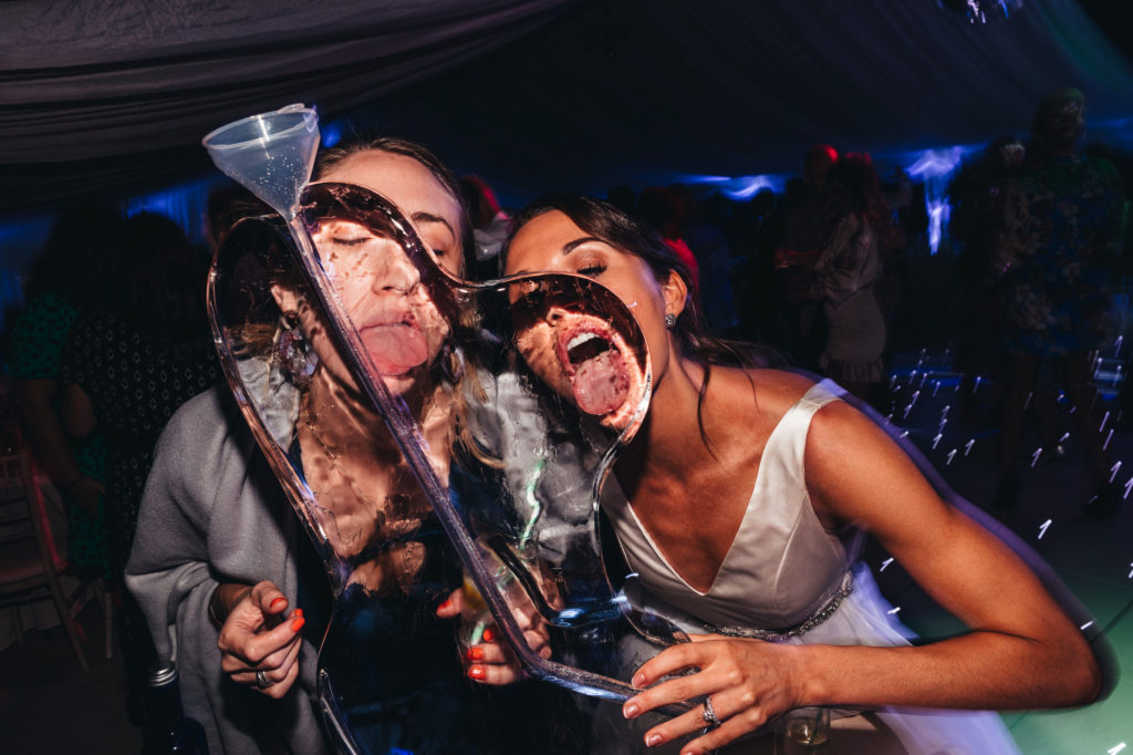 bride and friend lick ice