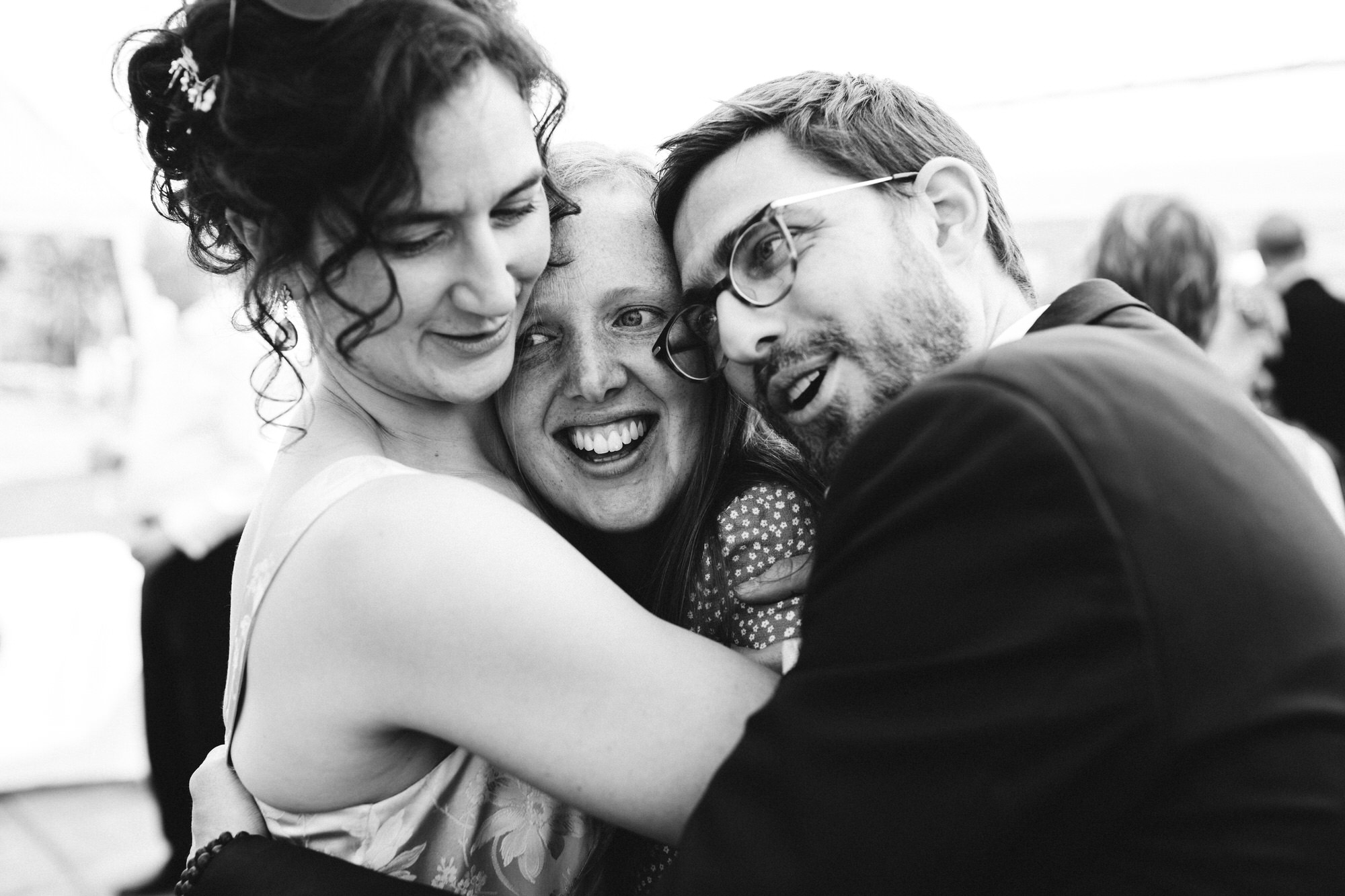 couple both squeeze and hug a guest with love