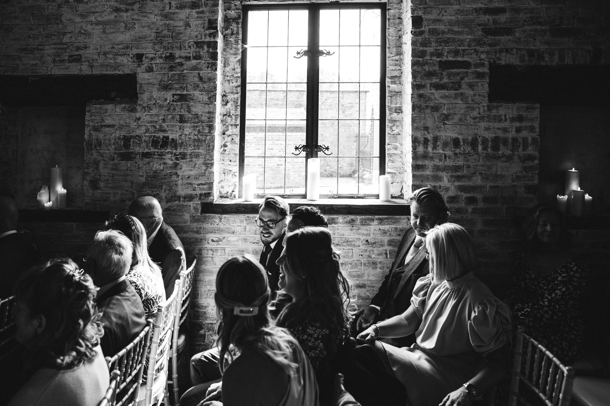 moody black and white shot of guests inside coach house