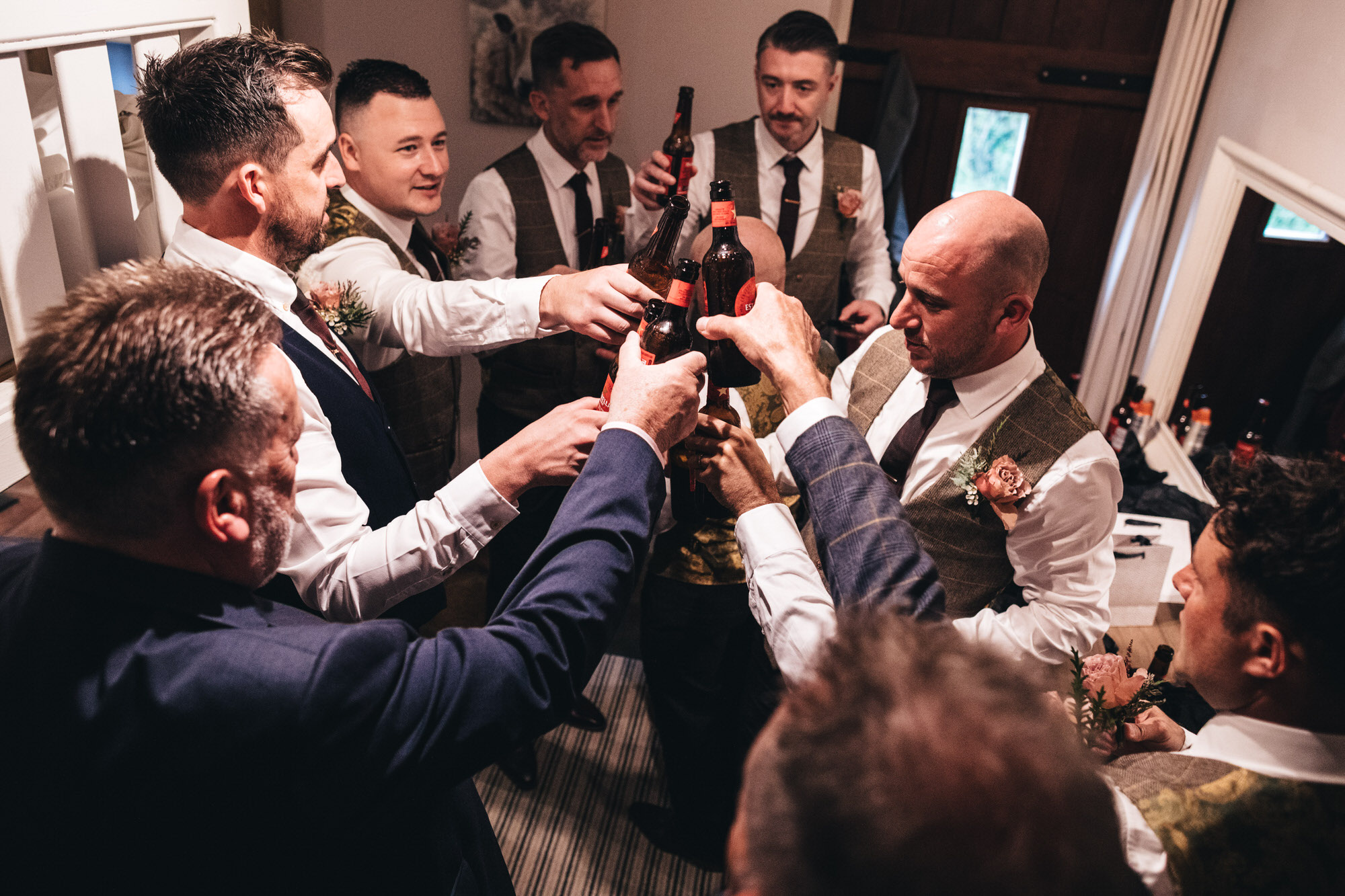 groomsmen chink beer bottles