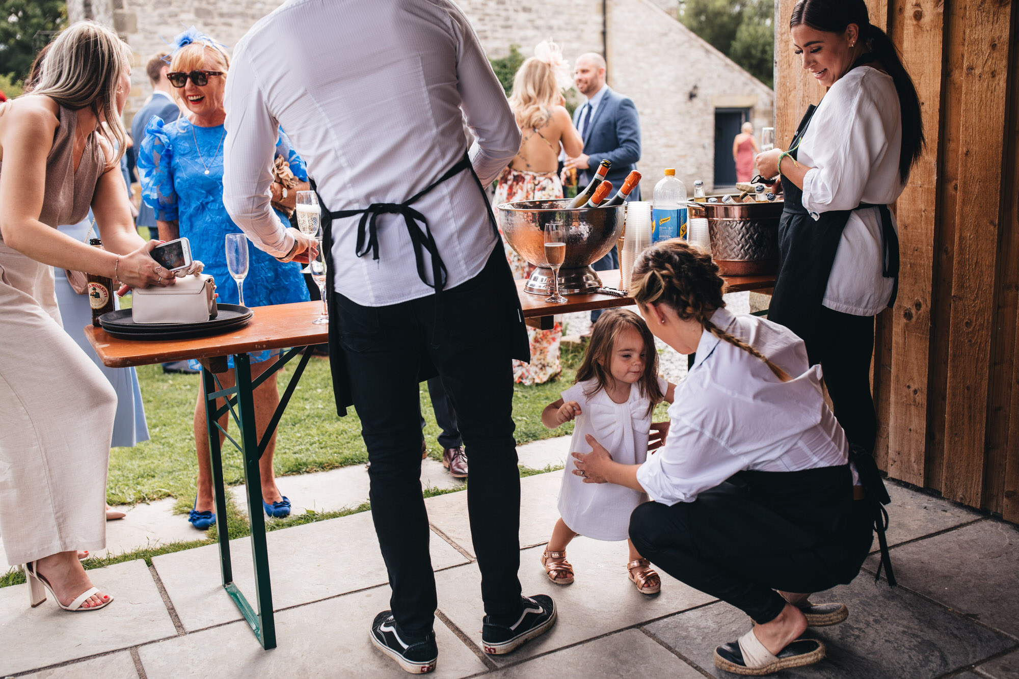 flower girls walks under the bar drinks table