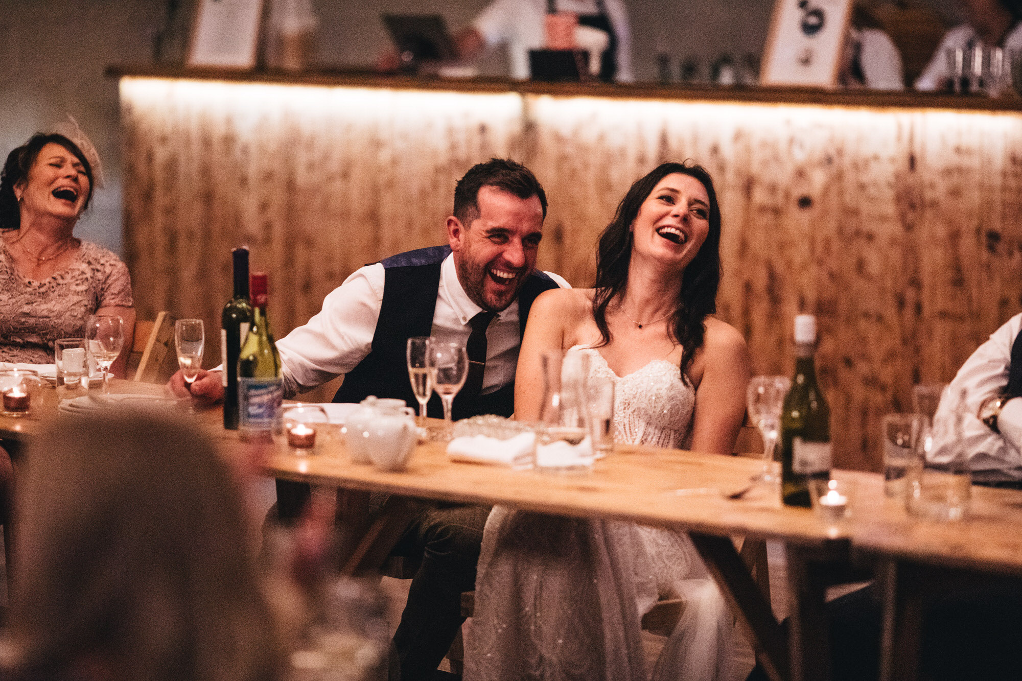 couple laugh during wedding speech