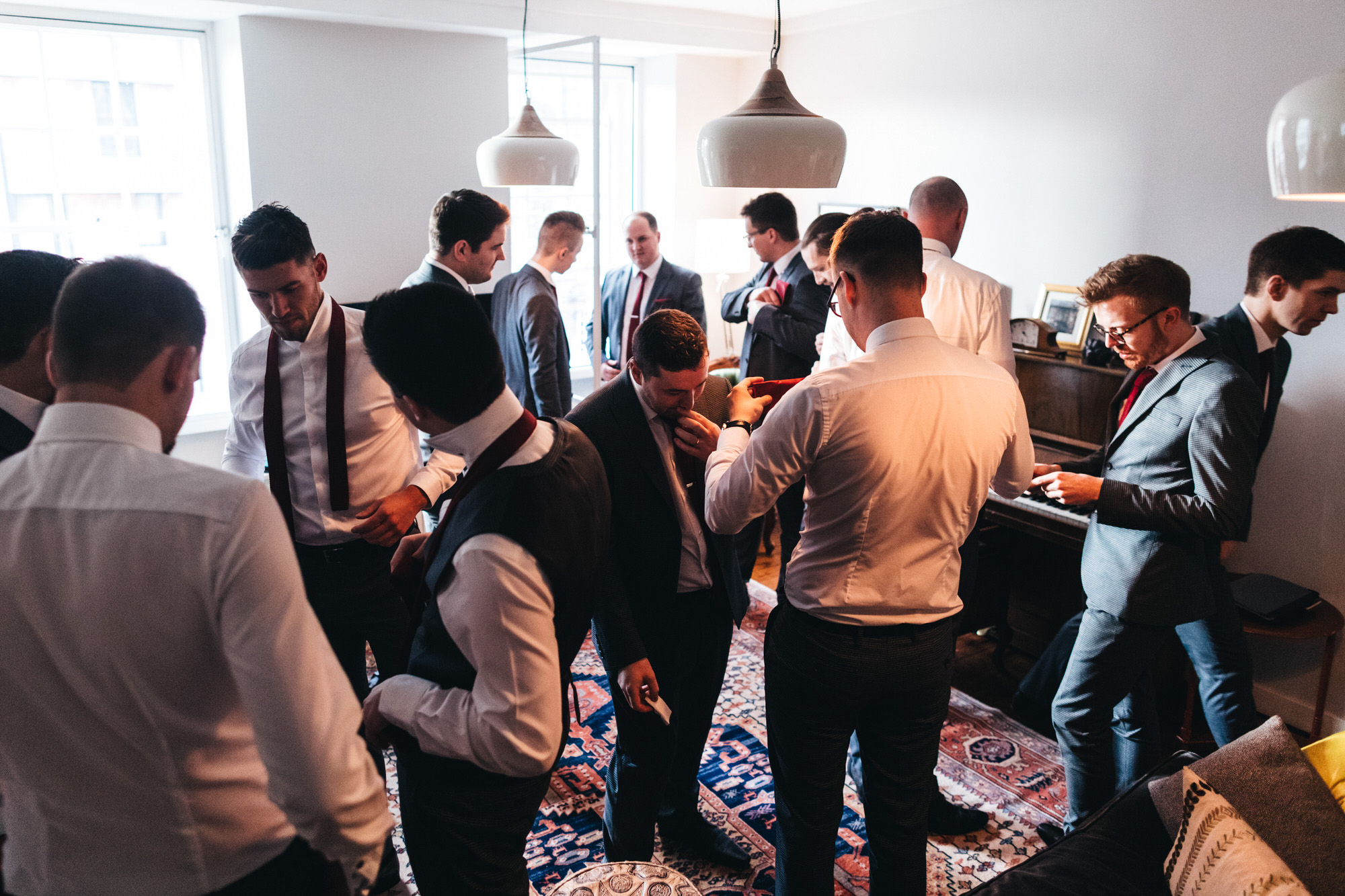loads of groomsmen getting ready in one picture