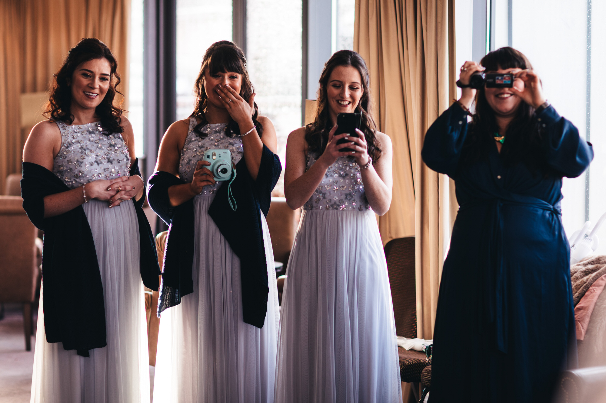 bridesmaids see bride for first time fully ready and get emotional