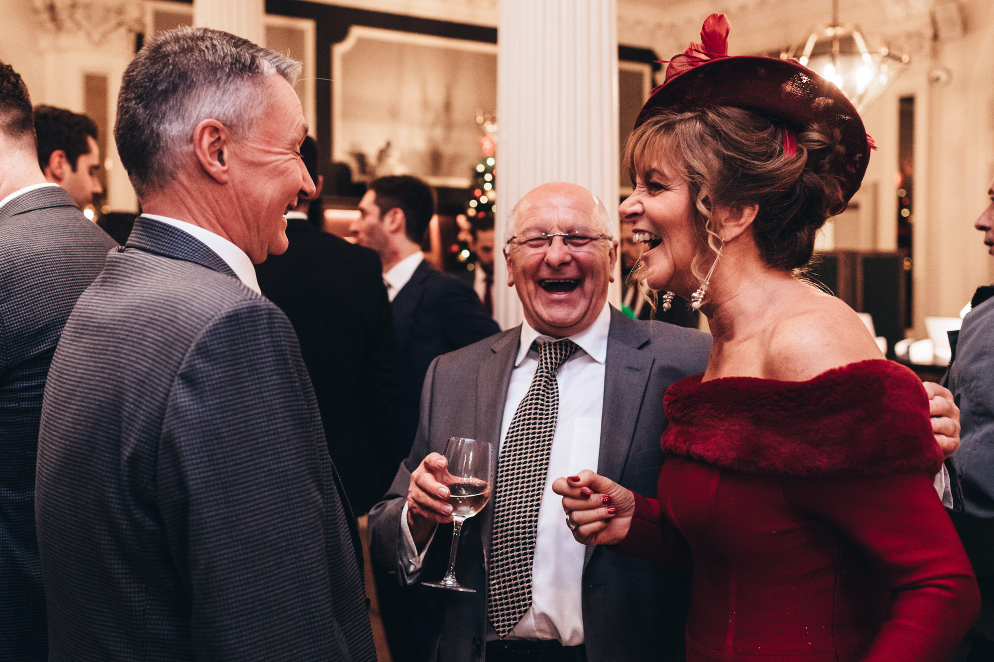 guests laugh at a wedding reception