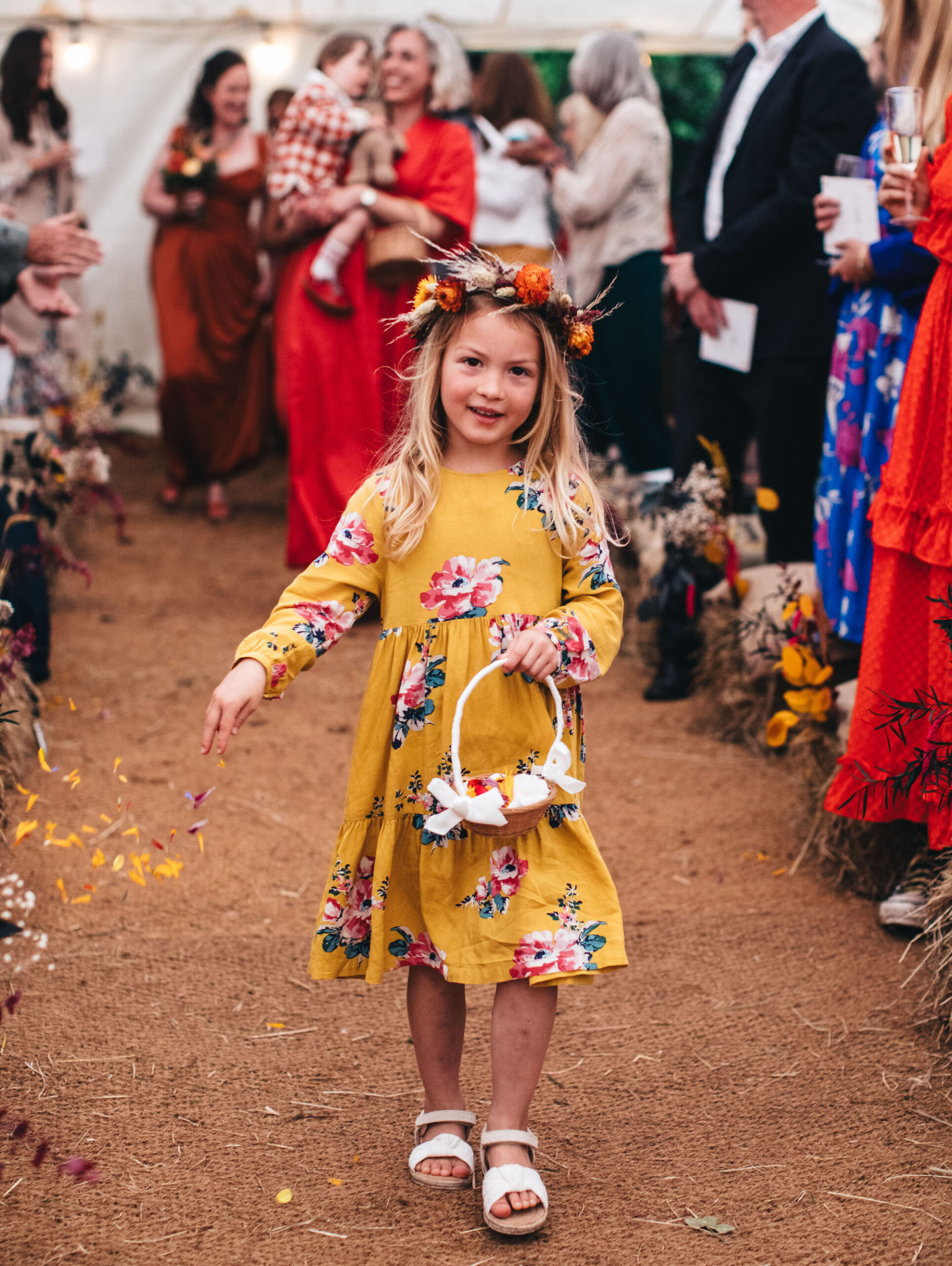 festival flower girl walking down aisle sprinkling petals, with floral headdress