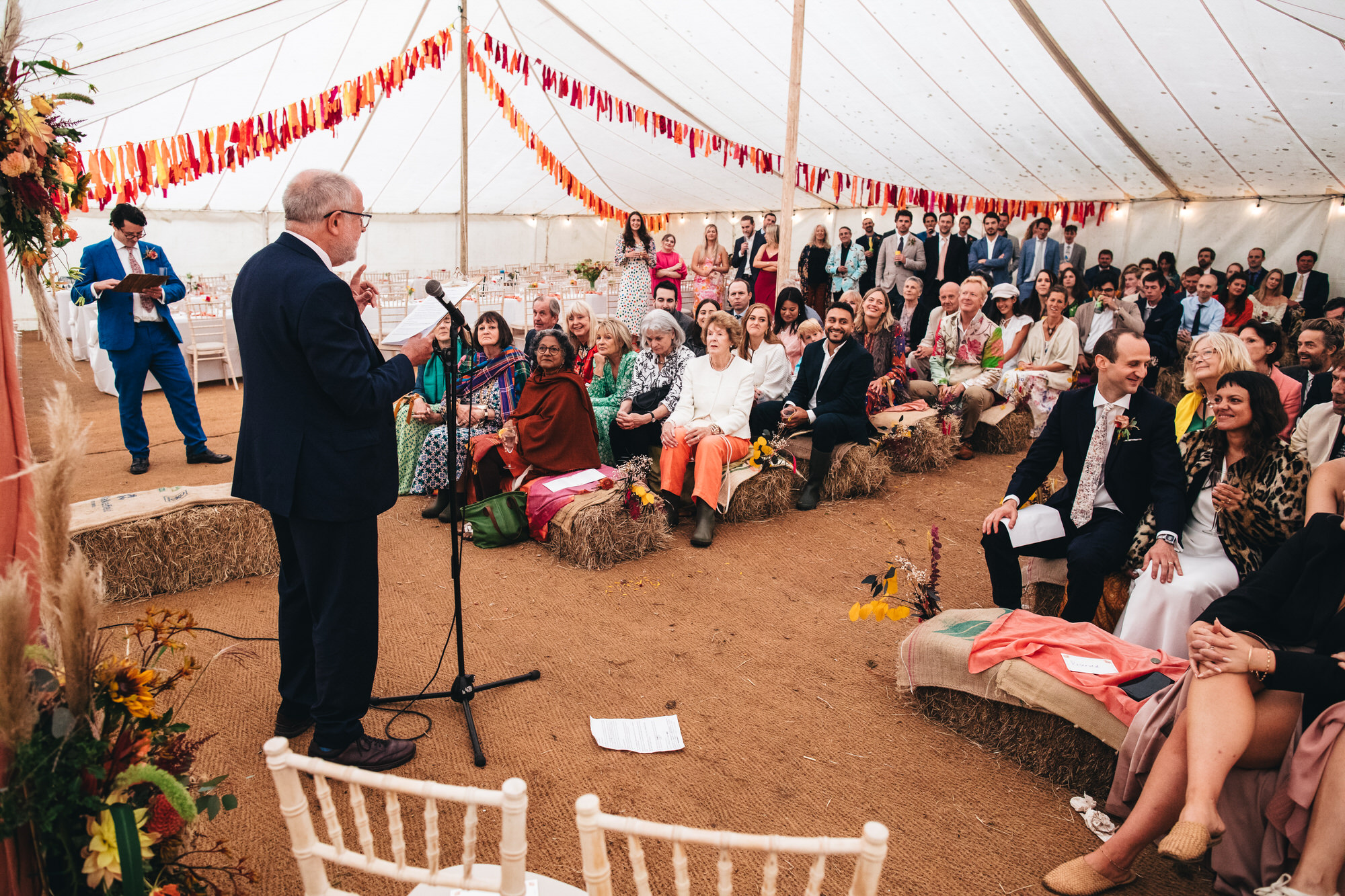 father of the bride making speech to guests in marquee tent