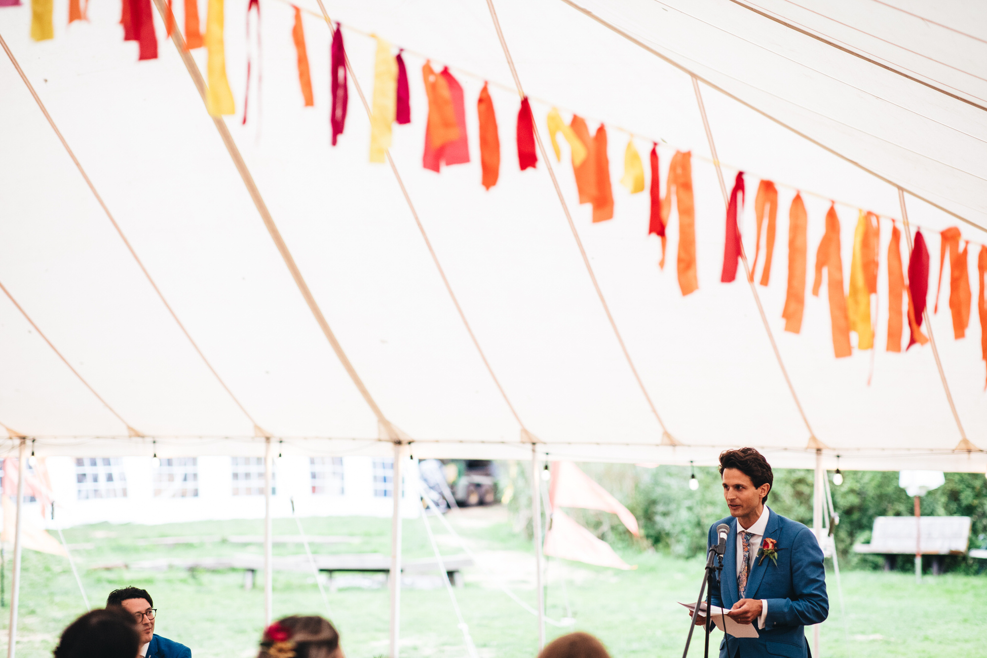 best man speech in marquee with festival bunting garlands
