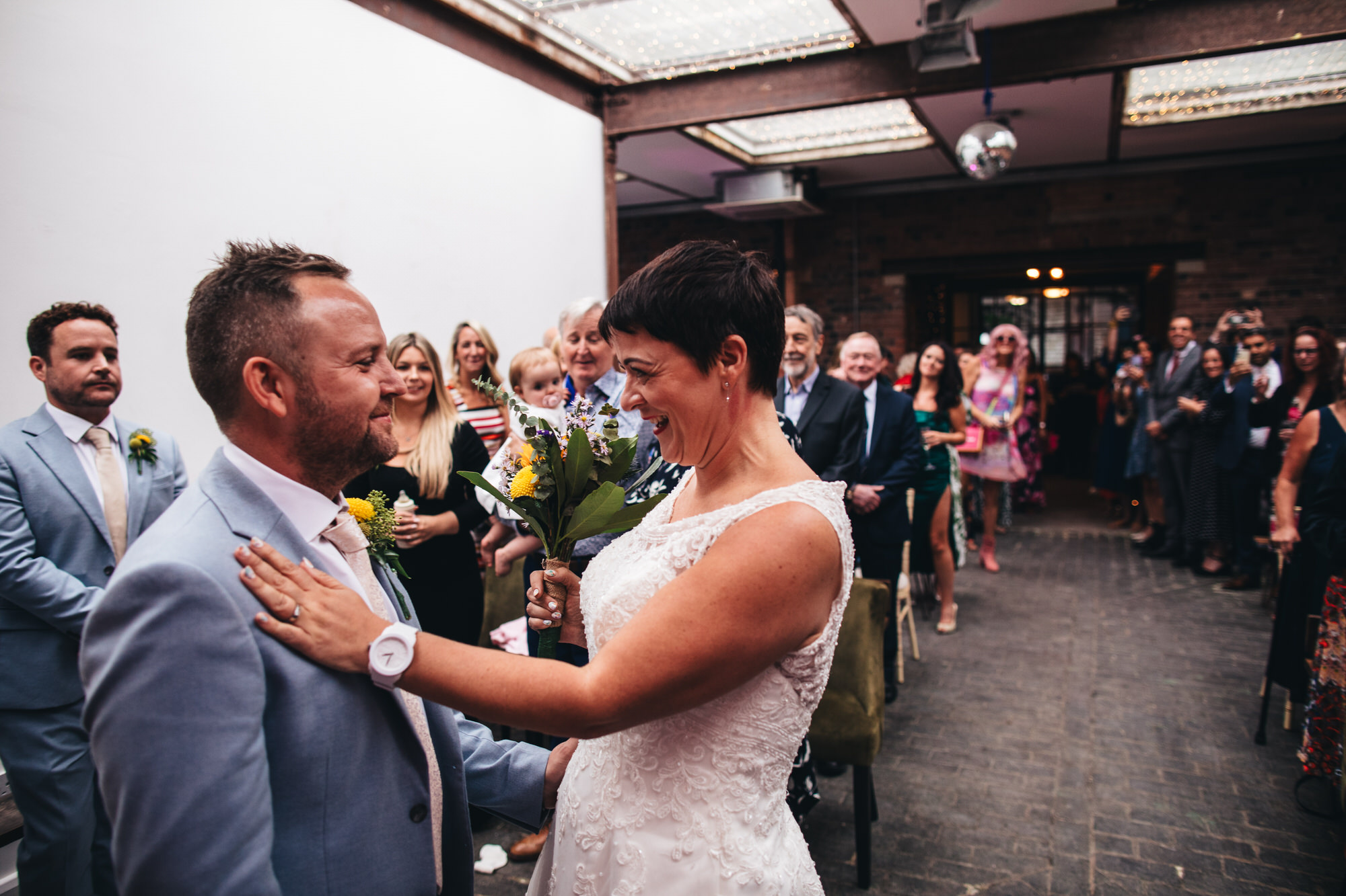 bride and groom smiling at ceremony