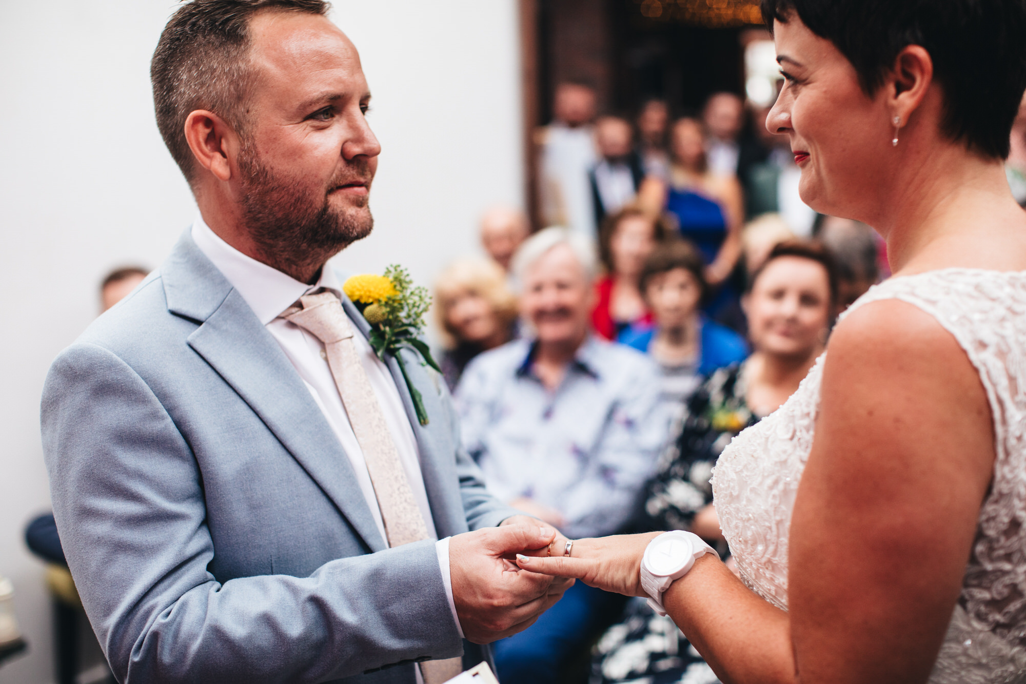 groom places ring on bride's finger
