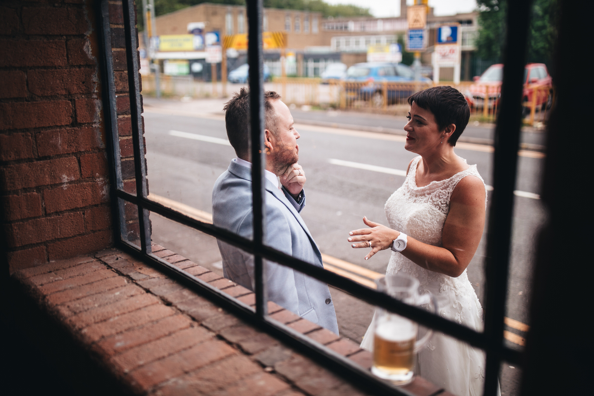 bride and groom talking through window
