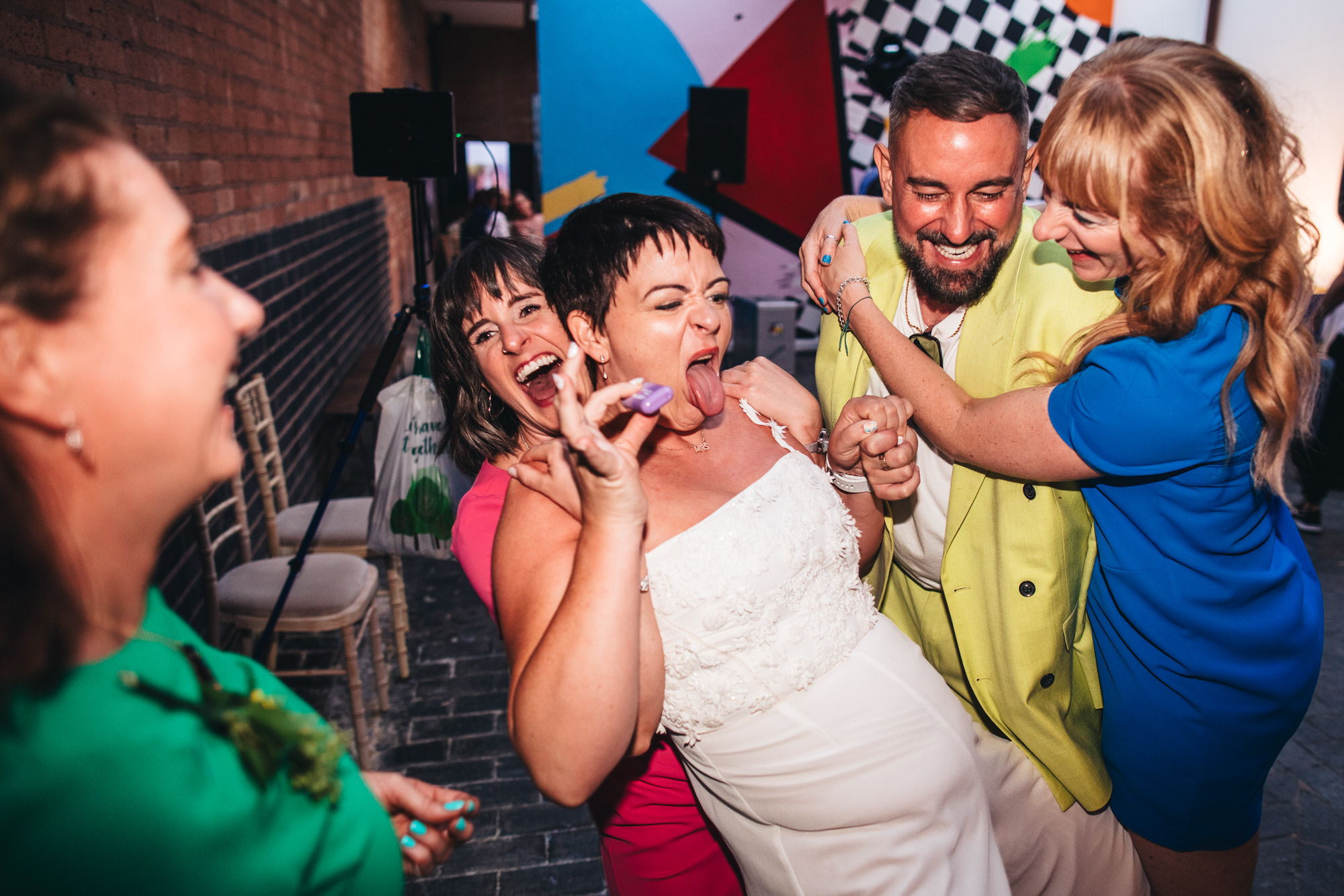 bride laughing joking vaping playing with guests and bridesmaids
