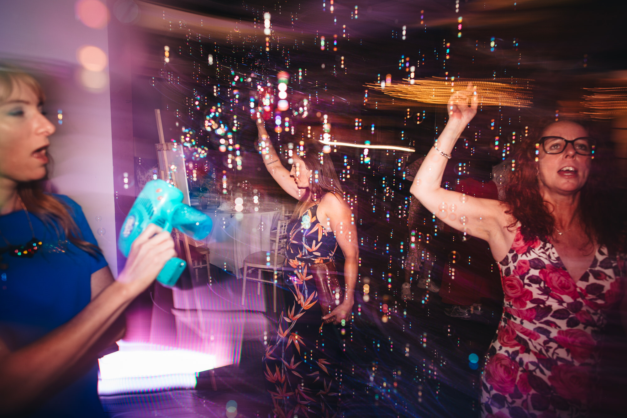 guests dancing in bubbles and light
