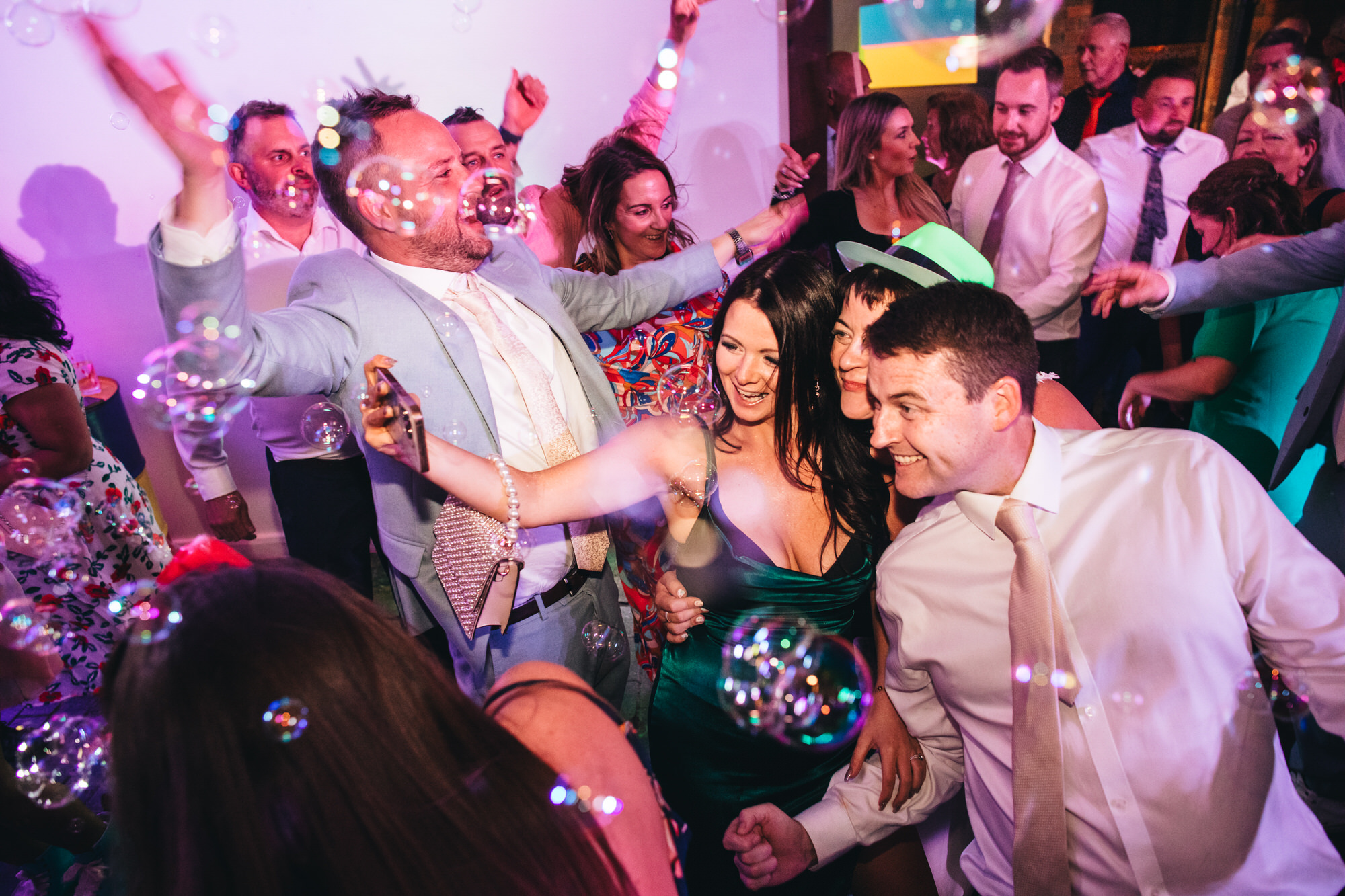bride poses for selfie photo with guests, bubbles
