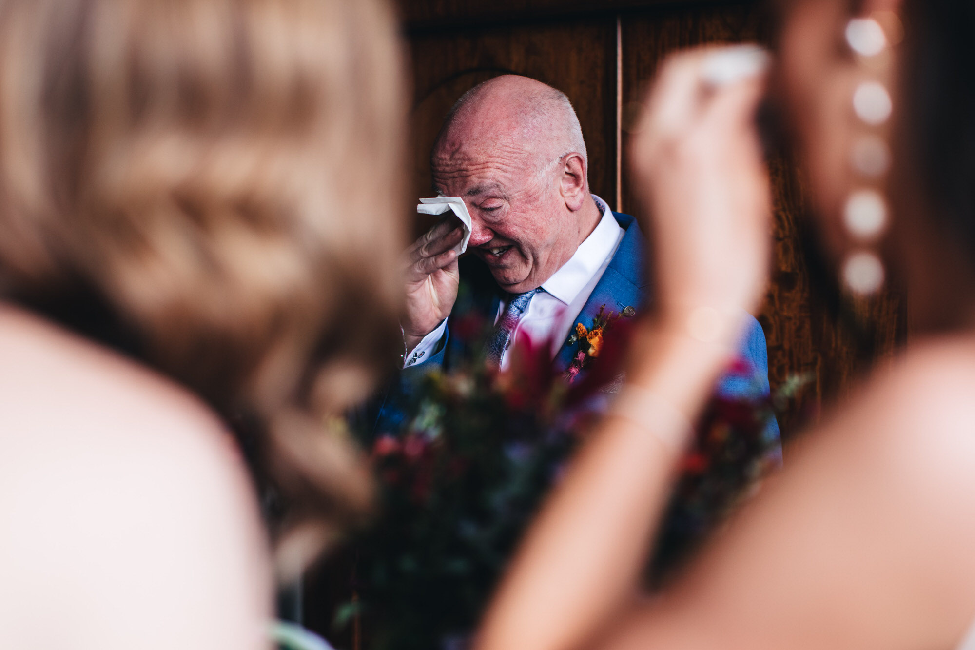 emotional father of the bride wiping away tears