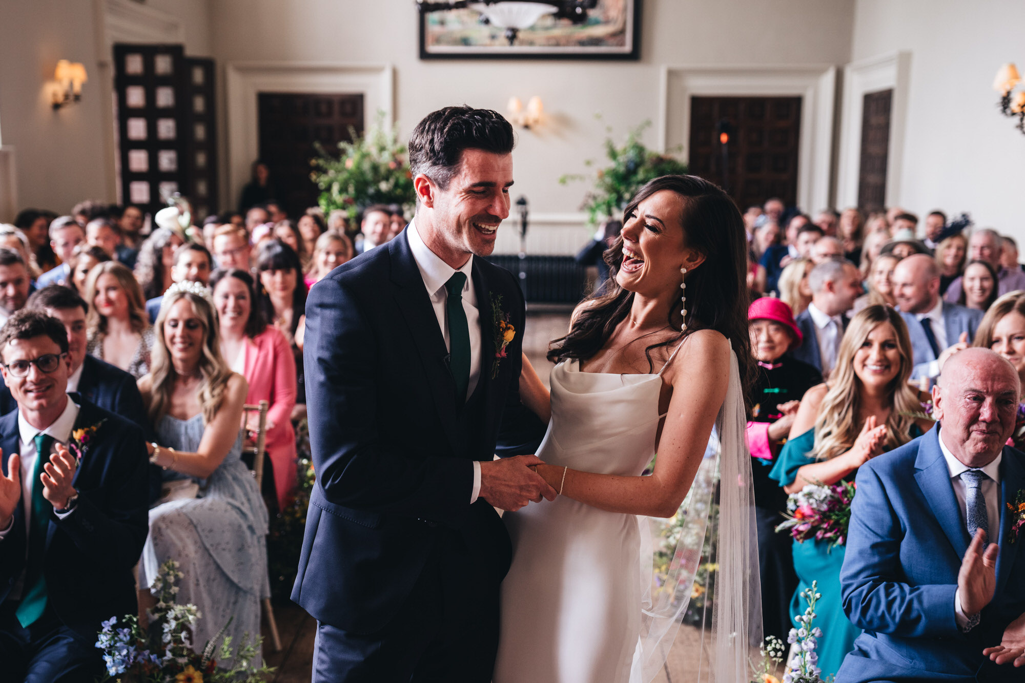groom and bride laughing at Elmore Court hall wedding ceremony