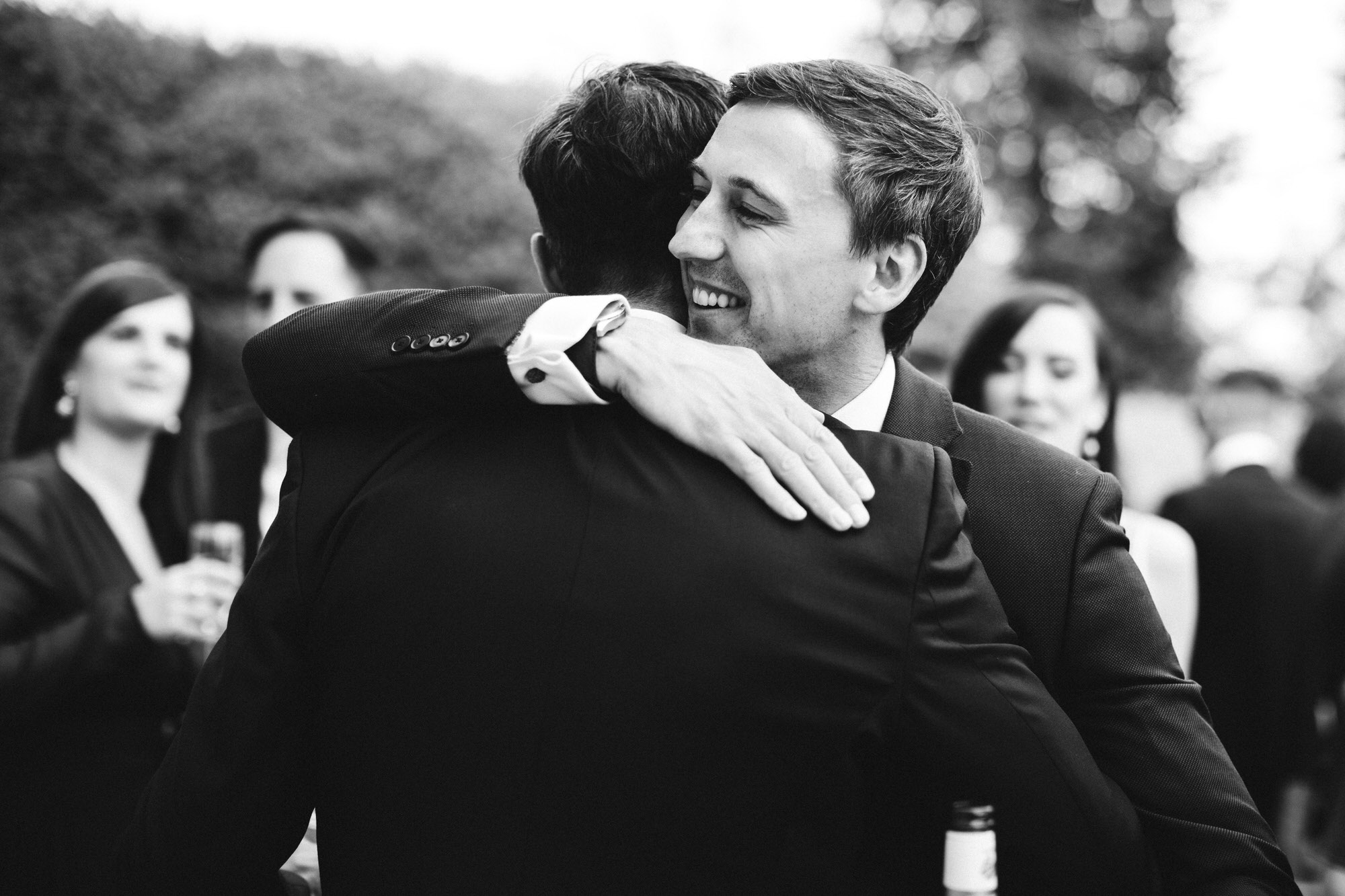 wedding guest hugging groom