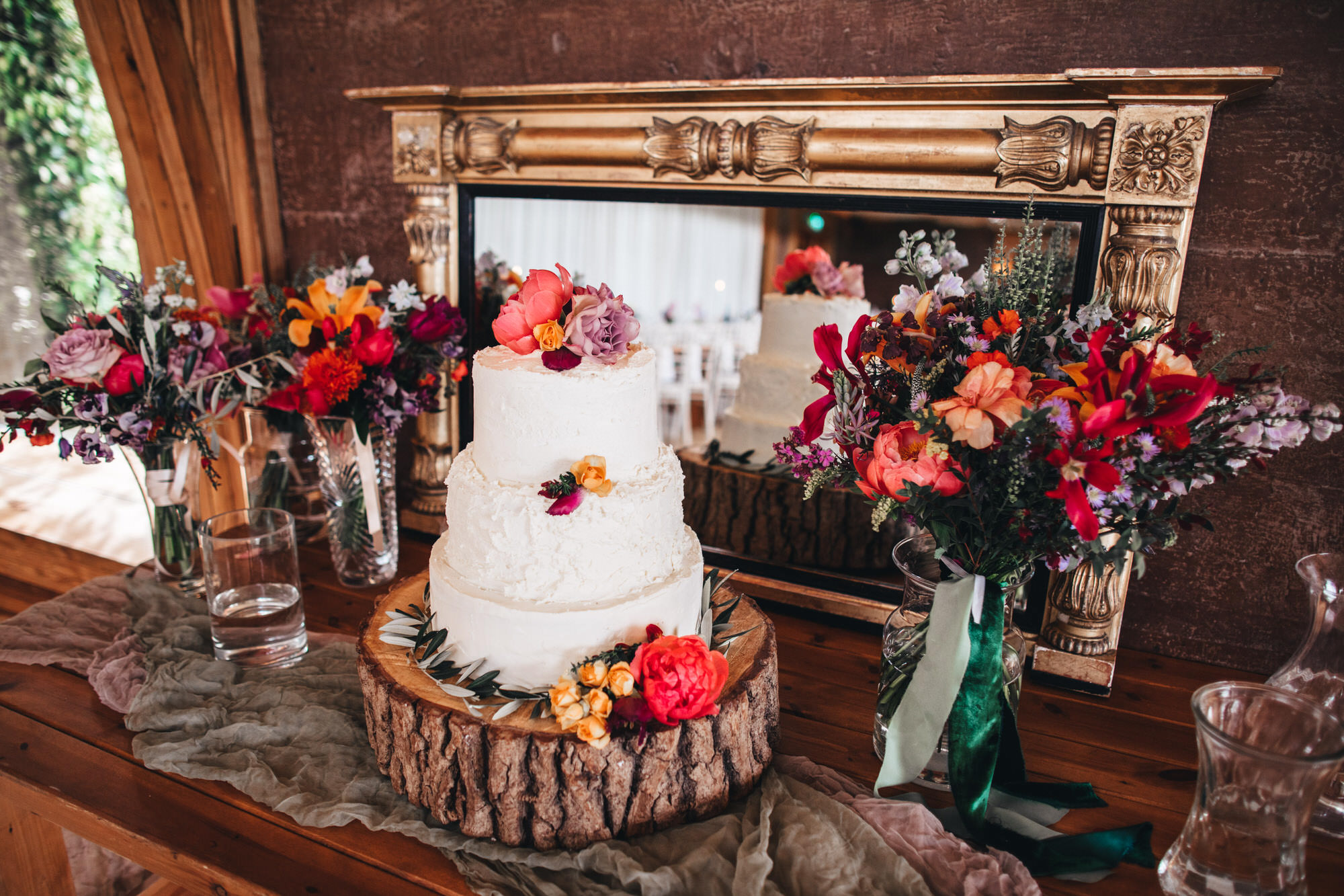 wedding cake with Wren and May floral arrangements