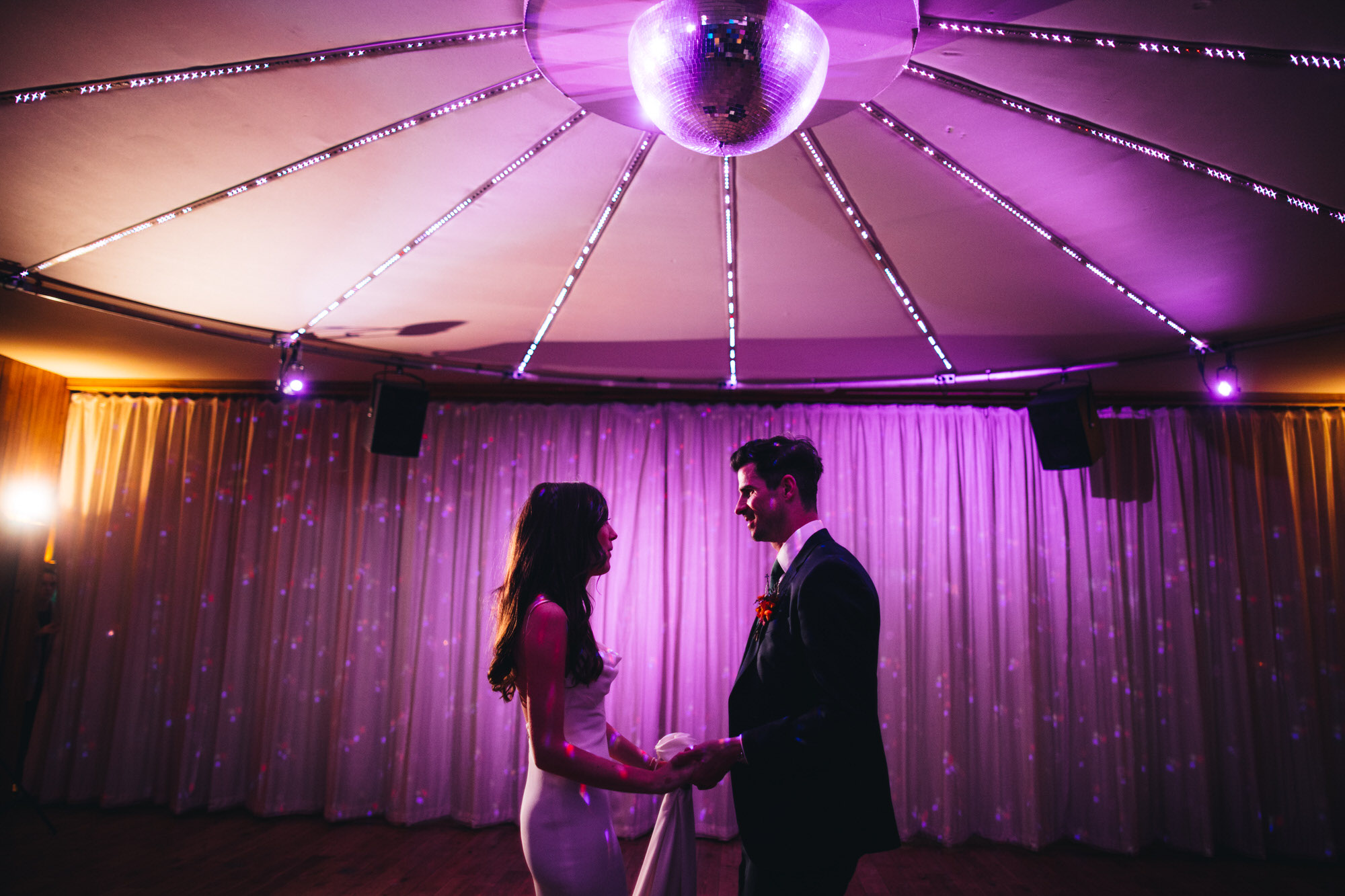 bride and groom under disco ball for first dance at wedding at The Gullyflower, Elmore Court