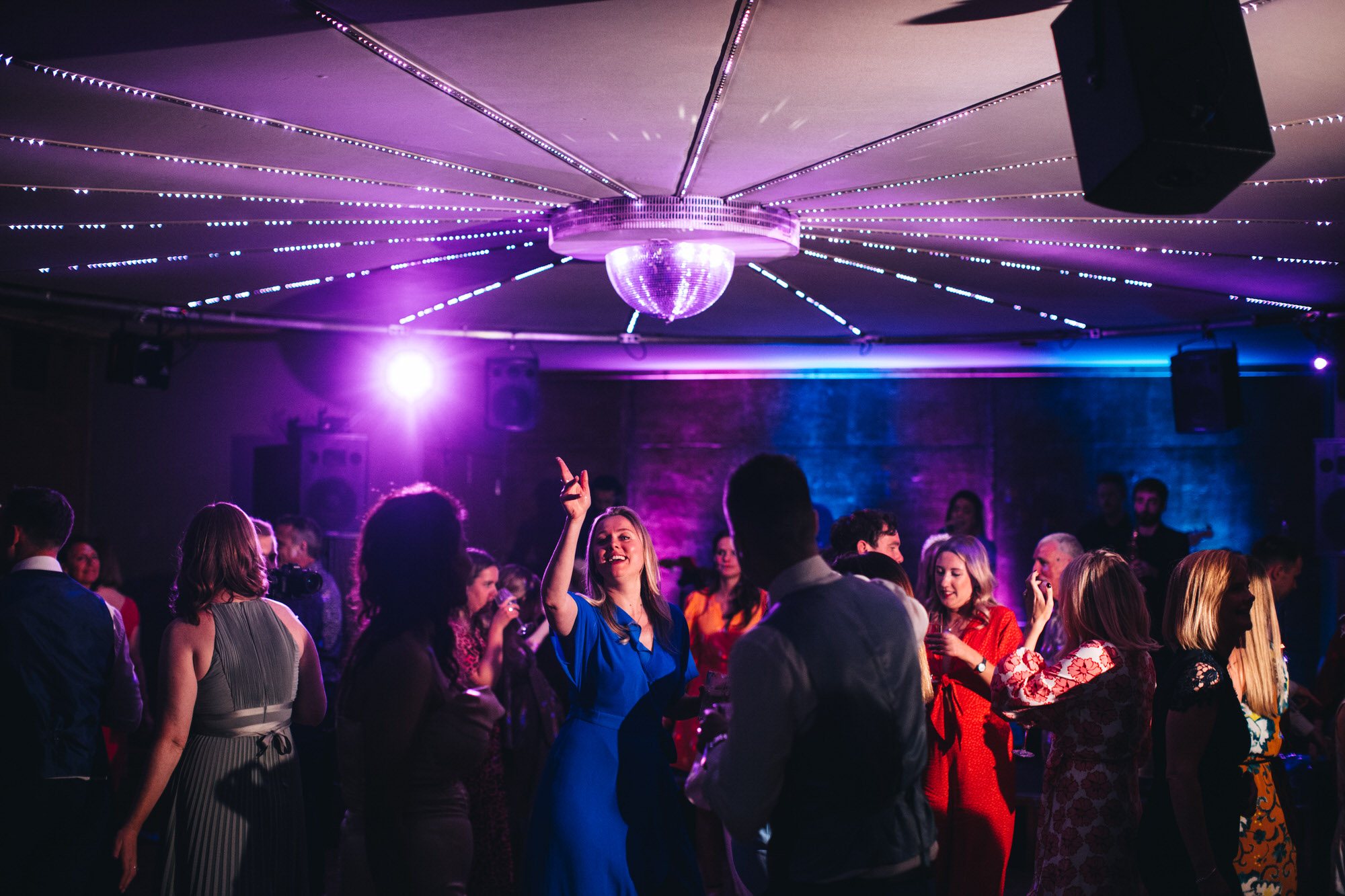 wedding guests dancing under disco ball inside The Gillyflower, Elmore Court, evening