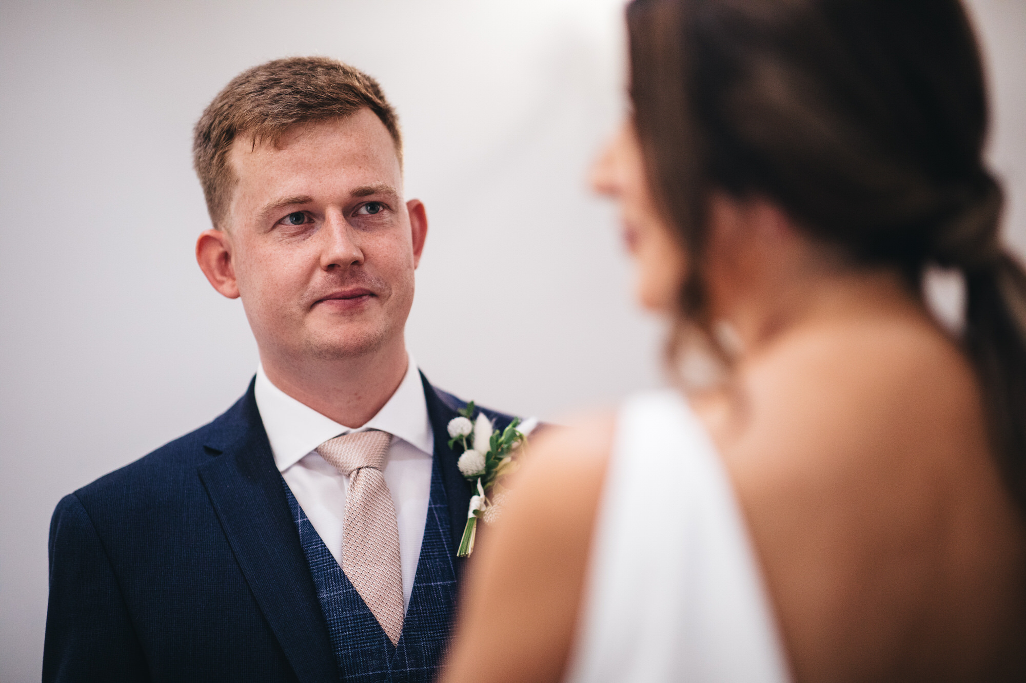 groom looking at bride
