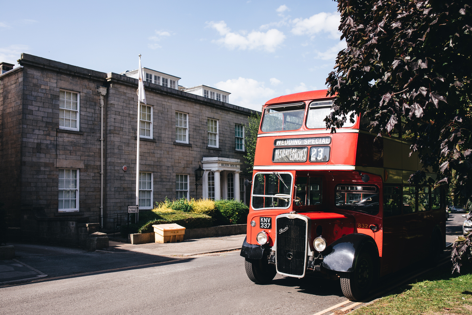red double decker wedding bus outside Bilton House