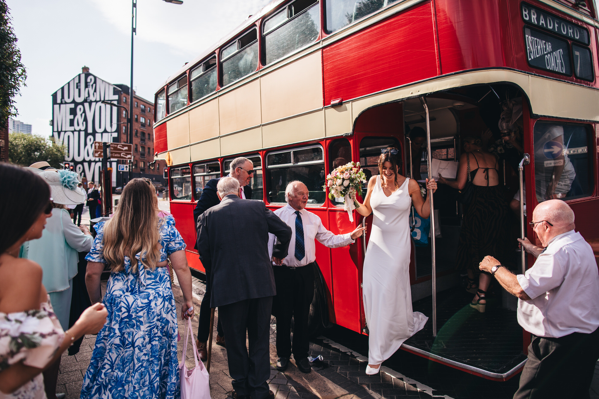 bride dismounts vintage wedding bus