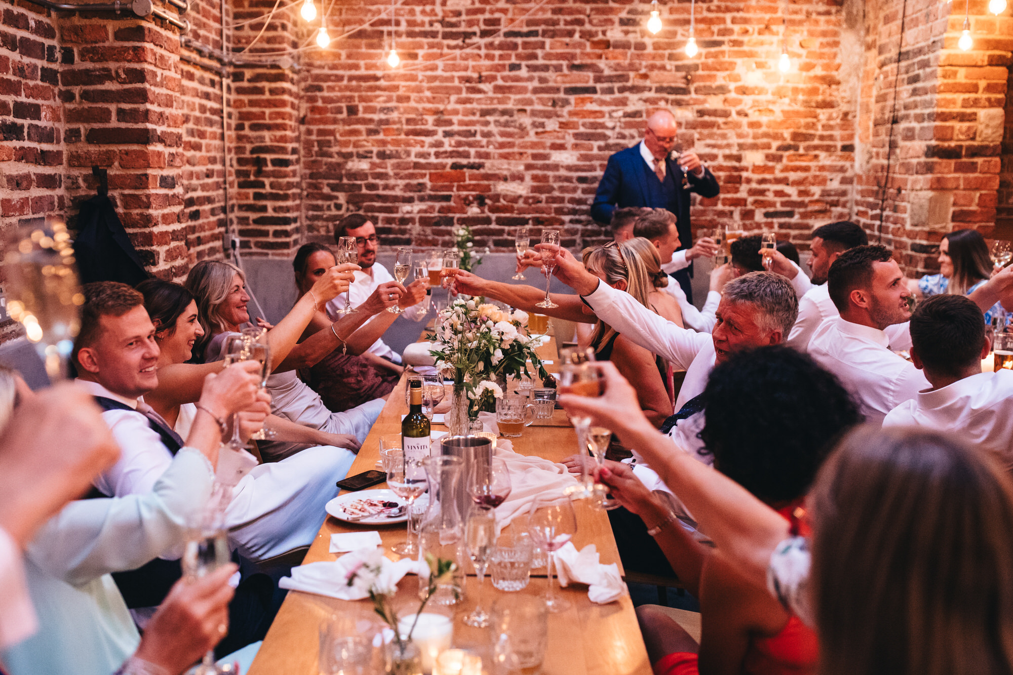 guests toast to bride and groom after speech