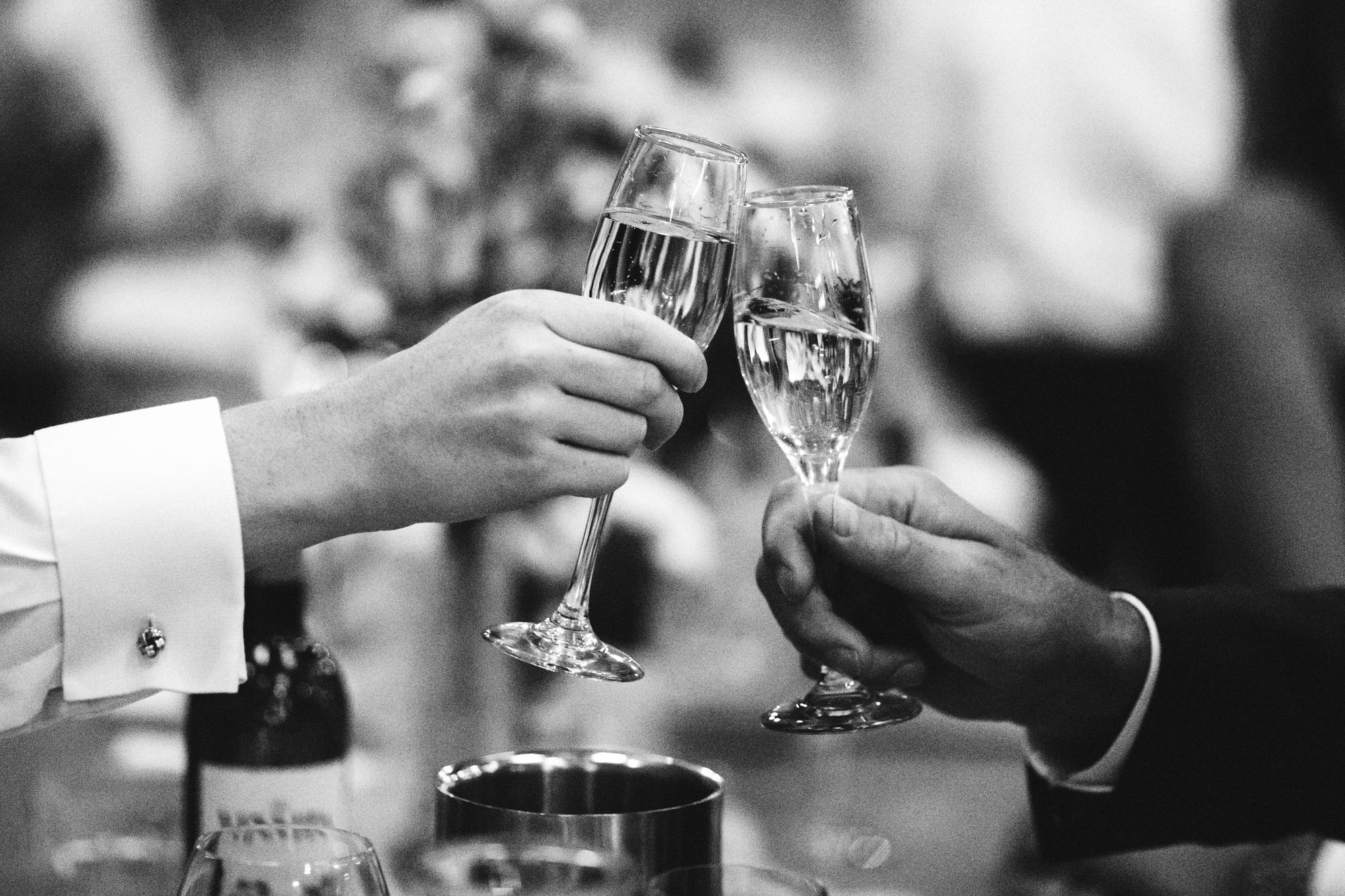 close of champagne glasses clinking, wedding toast