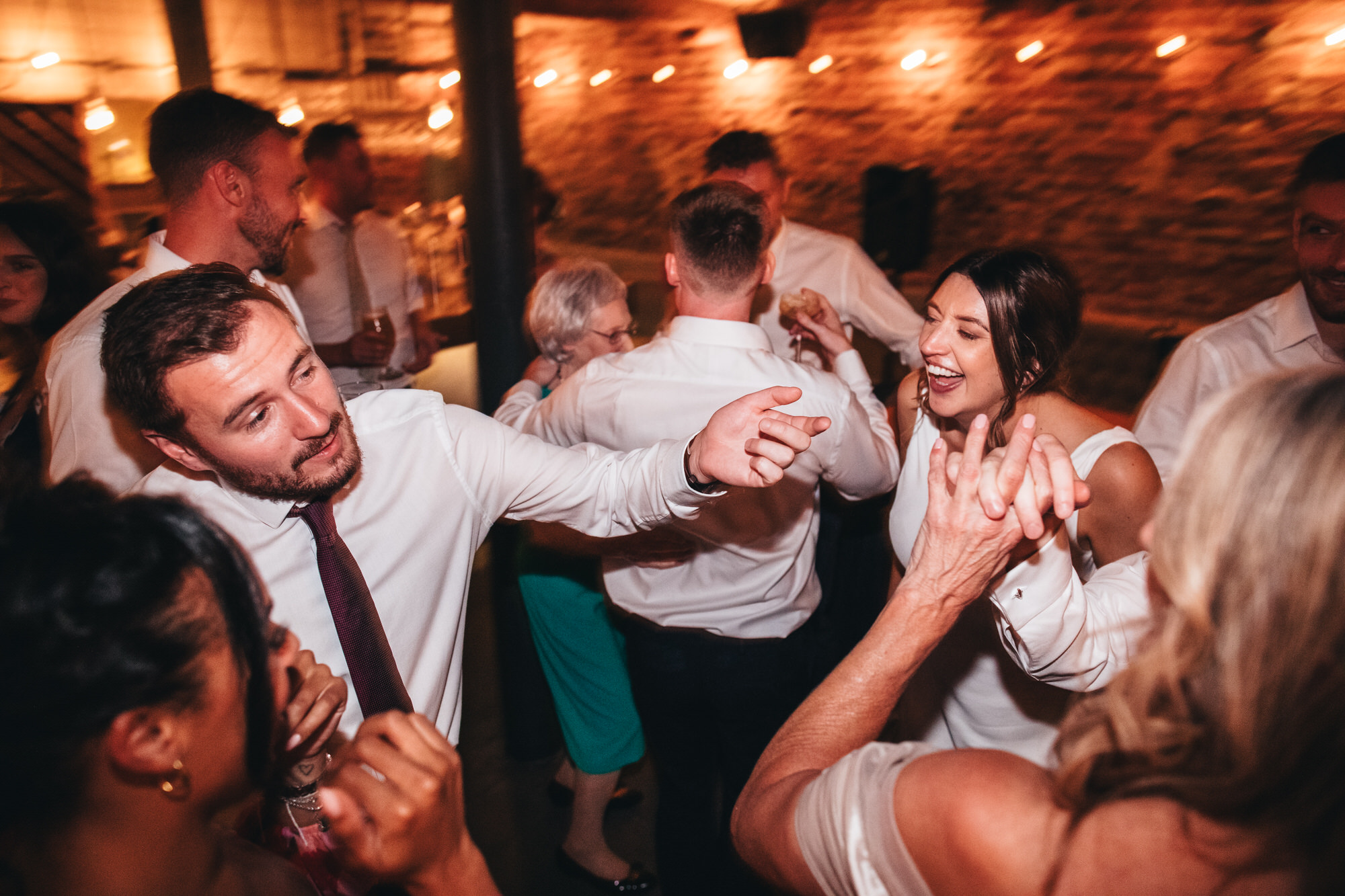bride dancing with friends and guests