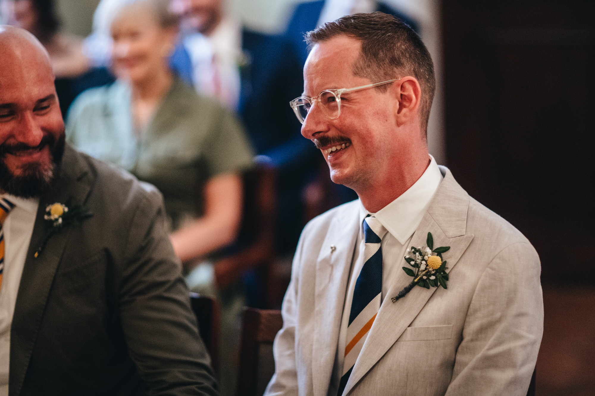 groom with moustache smiling at wedding ceremony