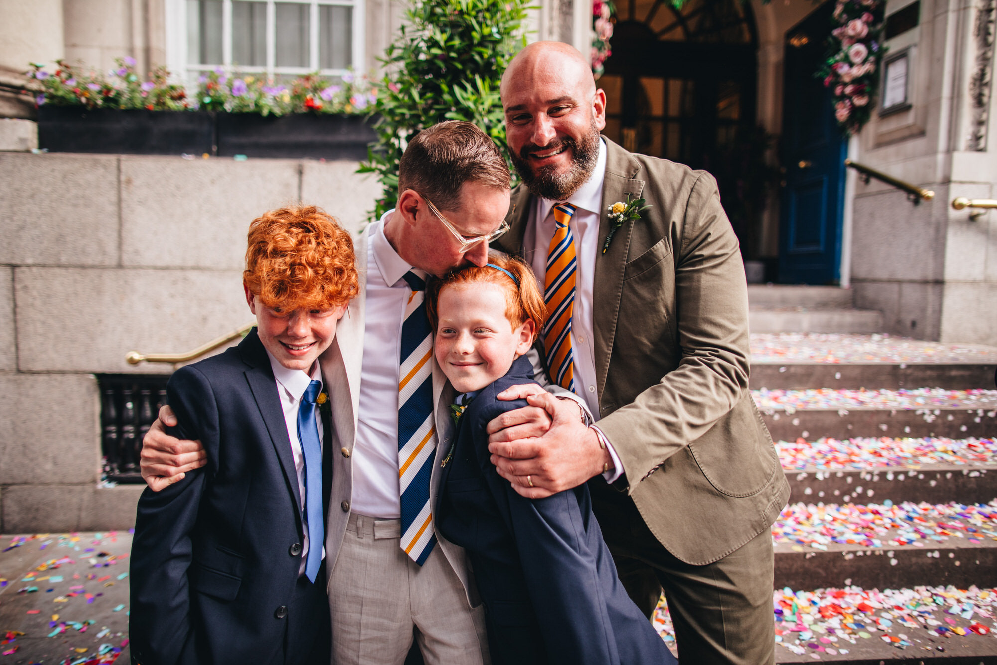 grooms hugging boys at London wedding