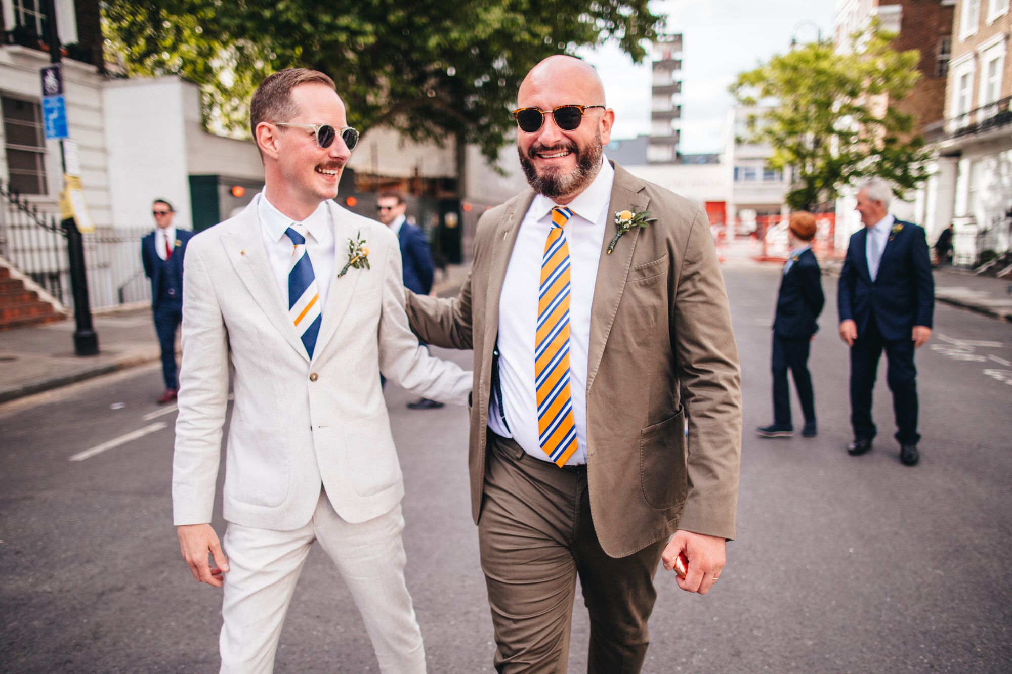 grooms walking together in wedding suits at London wedding, Chelsea wedding