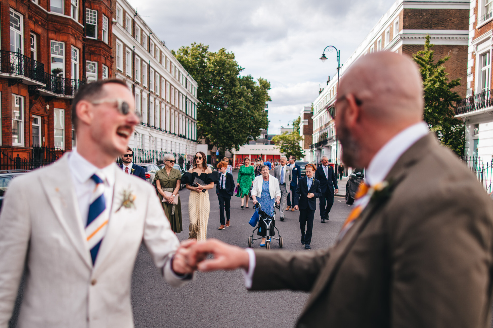 wedding guests walking down Chelsea street, LGBTQ+ wedding, London wedding