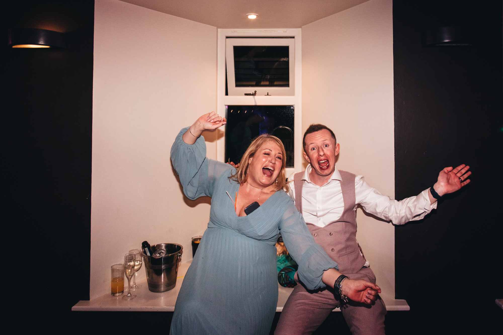 groom and guest pose for late night portrait, wedding party