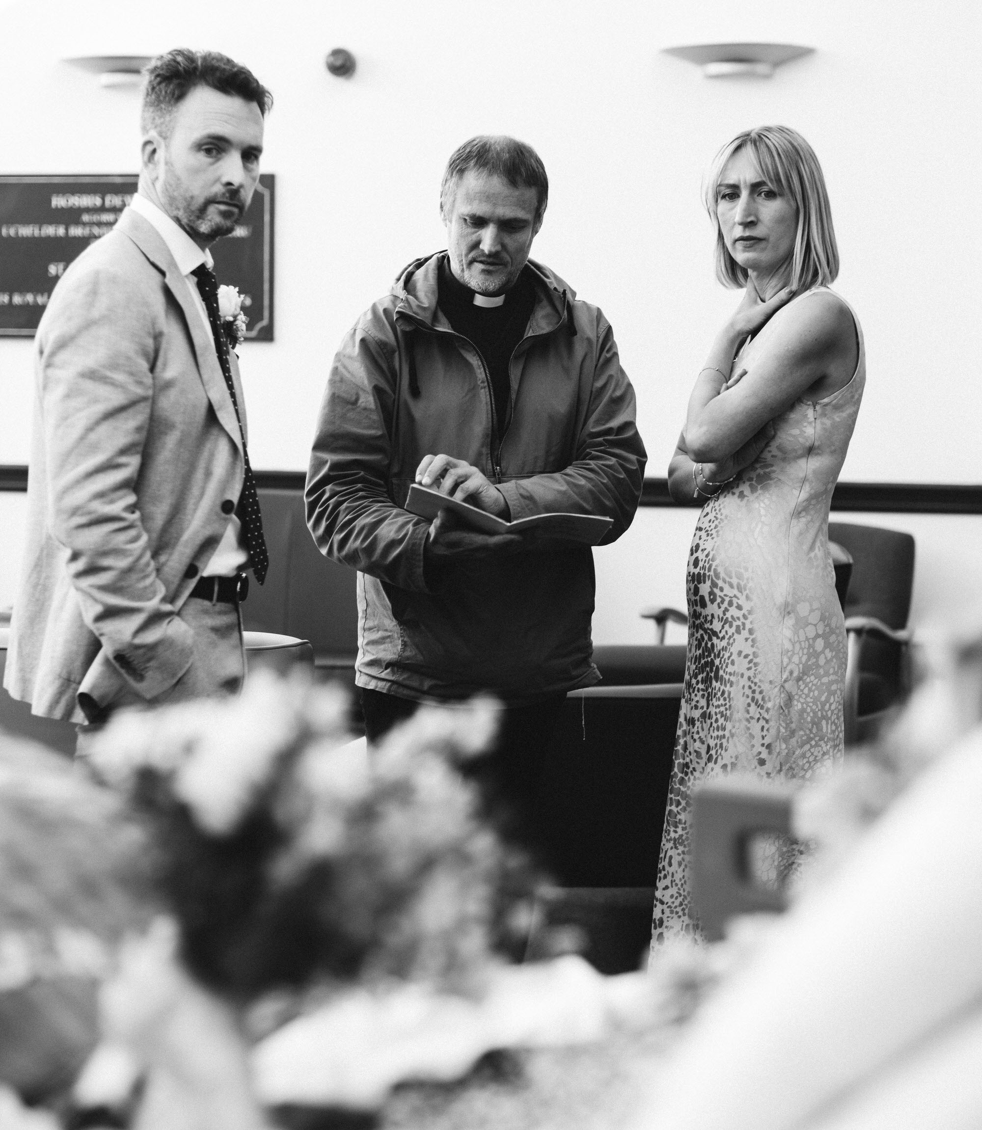 bride and groom with priest at hospital wedding ceremony, candid moments, documentary wedding photography